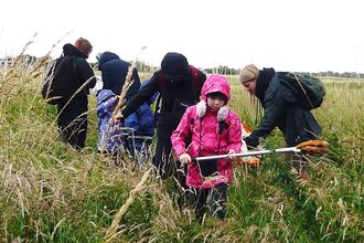 People working outside in grassland