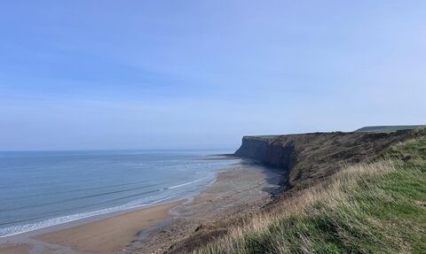 View of the sea, beach and cliff edge at Saltburn from Huntcliff cliff path