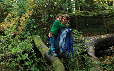 Father and son standing on a tree branch