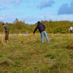 Volunteers raking wildflower meadow