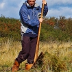 Volunteer raking wildflower meadow
